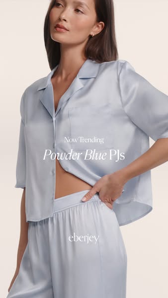 An image ad for Eberjey powder blue pajamas. A woman wearing the pajamas is centered in the image.