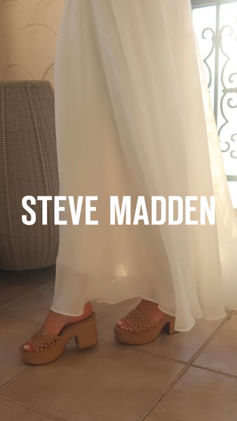 This image showcases a pair of Steve Madden platform shoes being worn with a long white dress. It is a simple product sh