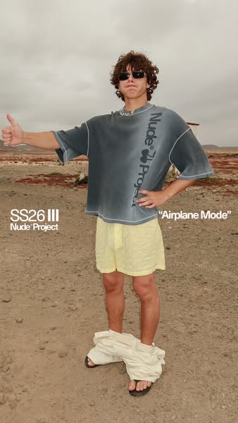 This image ad features a person outdoors, wearing a t-shirt with the brand's name on it. The individual is also wear