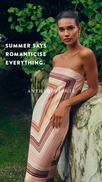 This Anthropologie ad features a woman in a chevron-striped dress leaning against a mossy wall, set against a backdrop o
