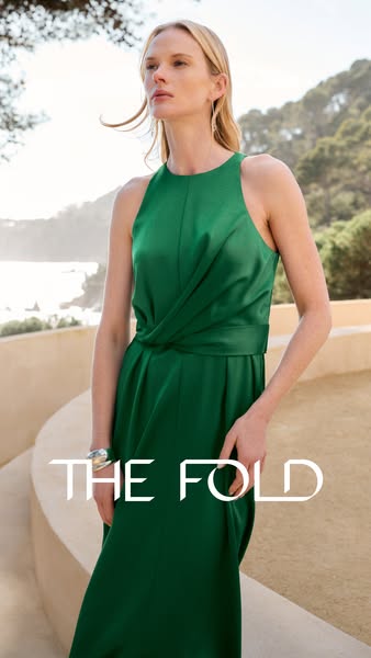 A stylish ad for The Fold features a woman in a green dress, promoting sophisticated fashion for professional women.