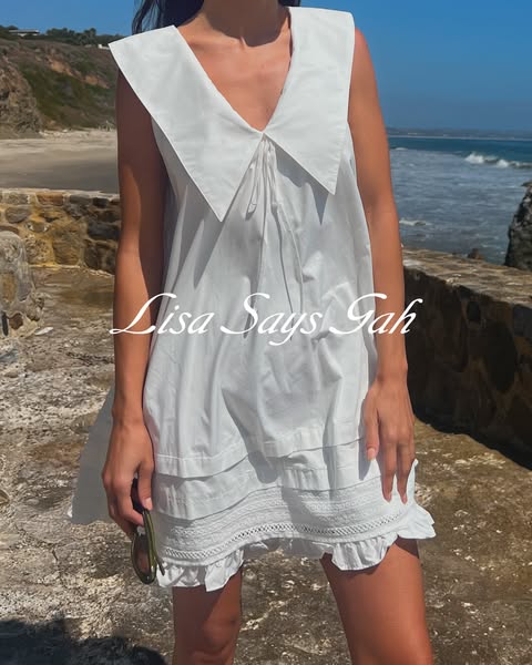 This image ad showcases a brand's white dress with a beachy backdrop.