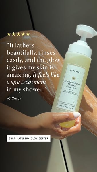 This ad features a close-up shot of a woman's arm and torso in the shower as she uses Naturium's Glow Getter Mul