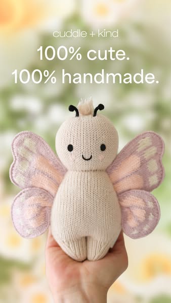 An image ad for Cuddle + Kind featuring a close-up shot of a knit doll being held in a person's hand. The ad highlig