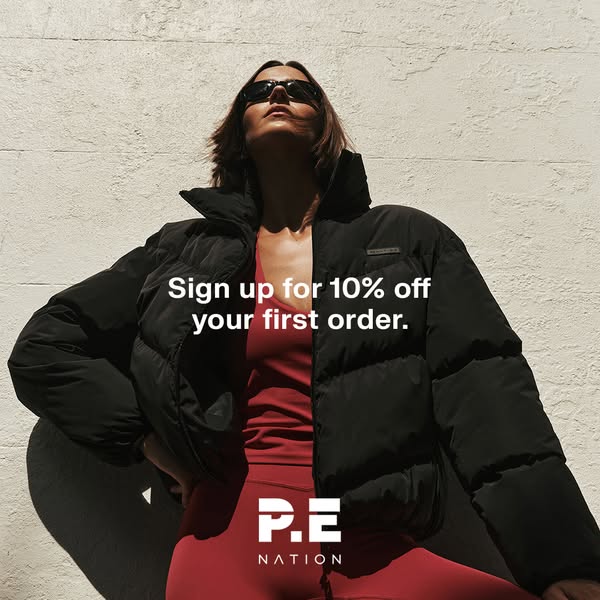 An image ad for P.E Nation features a woman in red leggings and top with a black puffer jacket. The ad promotes a sign u