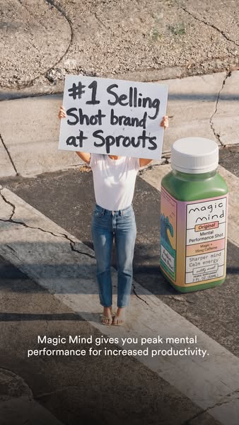 This ad features a woman standing on a street next to an oversized Magic Mind bottle, while holding a sign that says Mag