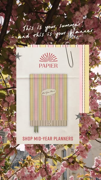 This ad is for Papier mid-year planners. The ad features a Papier planner against a backdrop of cherry blossom trees, wi