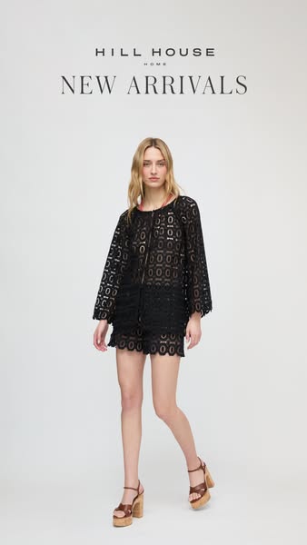 This Meta ad showcases a woman modeling a black lace blouse and matching shorts from Hill House Home's new arrivals.