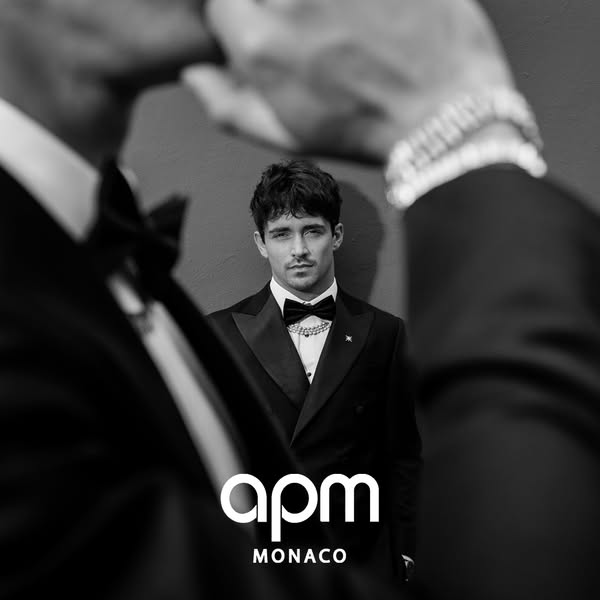 This black and white image ad features Charles Leclerc wearing APM Monaco jewelry. The ad is a close-up shot of Leclerc 