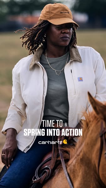 A vertical image shows a woman on horseback wearing a Carhartt jacket and hat. The ad encourages viewers to 'Spring 