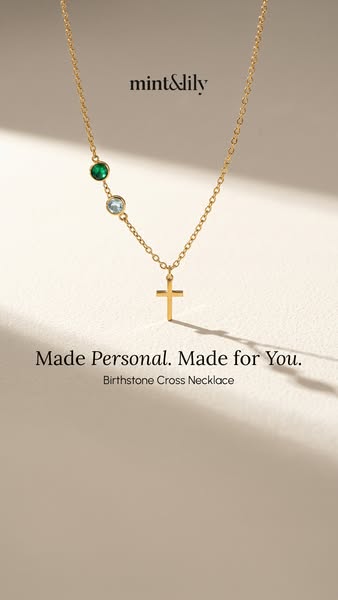 This image ad showcases a personalized birthstone cross necklace from Mint & Lily. The necklace is gold and features