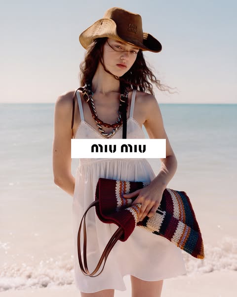 A fashion-focused advertisement showcasing a woman on a beach with a Miu Miu handbag.