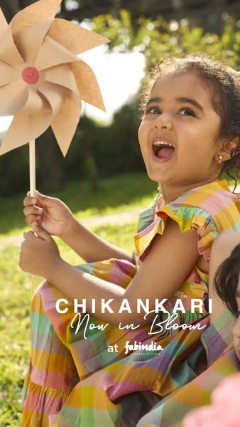 This ad features a young girl holding a pinwheel while sitting outdoors. The ad is promoting Fabindia's new line of 