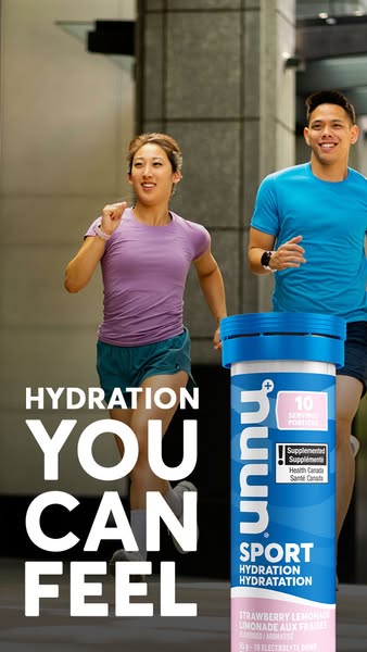 This ad features a sporty couple in workout attire running outside with a large tube of Nuun Sport Hydration tablets dis