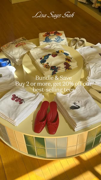 The ad promotes Lisa Says Gah best-selling tees. The ad includes an offer to bundle and save. If you buy 2 or more of th