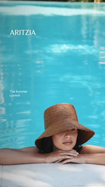 This ad showcases the brand Aritzia's summer launch, featuring a woman in a pool wearing a sun hat.