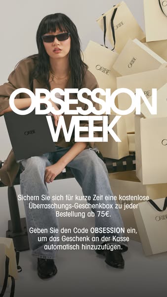 An ad for Oribe 'Obsession Week' shows a person sitting with an Oribe product while surrounded by Oribe shopping