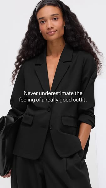 This ad features a woman in a black blazer and pants, with the text overlayed, "Never underestimate the feeling of 