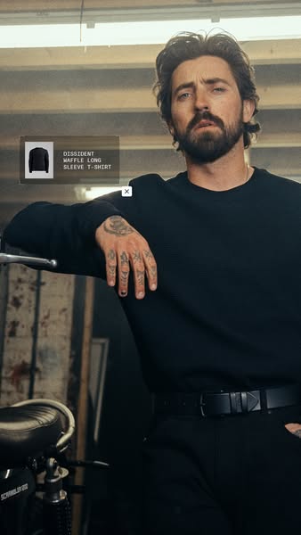 The ad features a man leaning against a motorcycle, showcasing a waffle long sleeve t-shirt.
