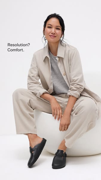 This image ad features a woman sitting on a white chair wearing a casual outfit and black clogs. The ad highlights the c