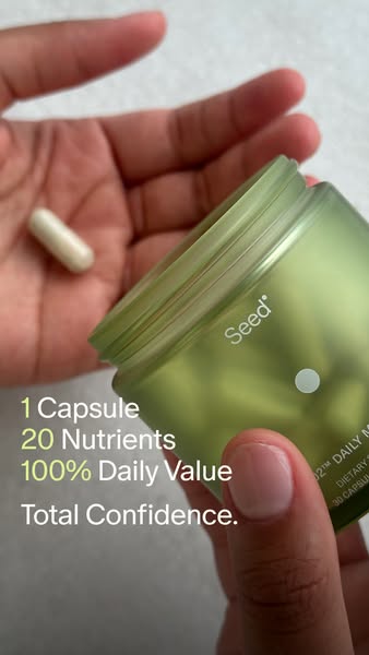 This ad features a hand holding a Seed probiotic capsule and a jar of Seed probiotics. The ad highlights the product'