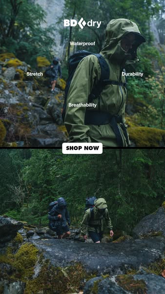 This image ad showcases Black Diamond's BD.dry waterproof jacket being worn by two individuals hiking in the rain. T