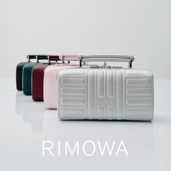 This ad showcases a row of RIMOWA Personal cases in different colors, highlighting the brand's design and aesthetic.