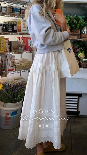 This ad features a woman in a grocery store wearing a long white skirt from the brand DÔEN. The ad highlights the skirt&