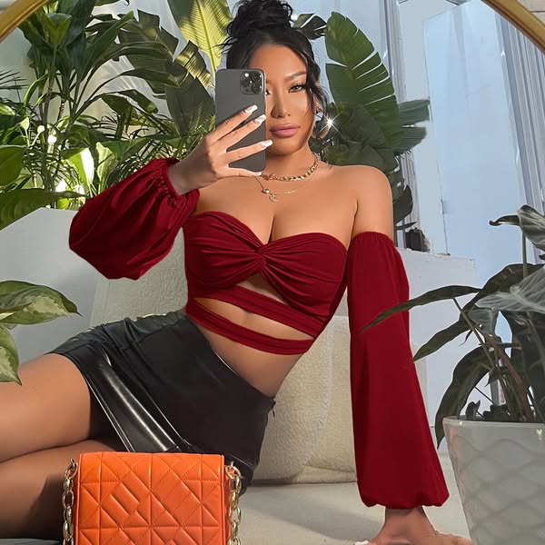 This ad features a woman taking a selfie while wearing a red top and black skirt. The ad is likely for a clothing brand.