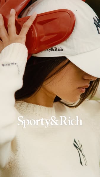 This image ad features a person wearing a Sporty & Rich baseball cap and sweater. The ad conveys a sense of casual l