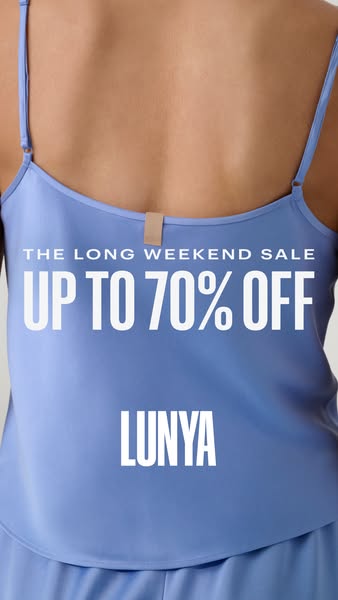 An image of a woman's back wearing a blue pajama camisole that is part of Lunya's long weekend sale.