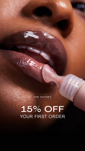 This ad features a close-up shot of a person applying The Outset lip gloss. The ad offers a 15% discount on the first or