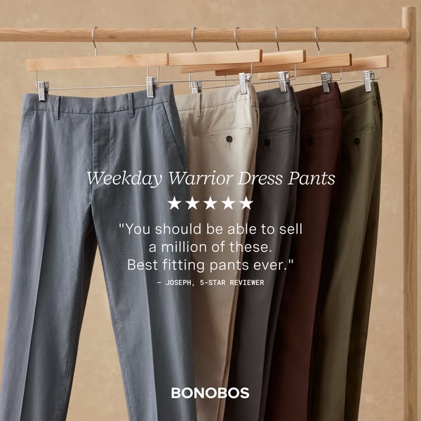 A product shot of Bonobos 'Weekday Warrior Dress Pants' in multiple colors hanging on a clothing rack. The headl
