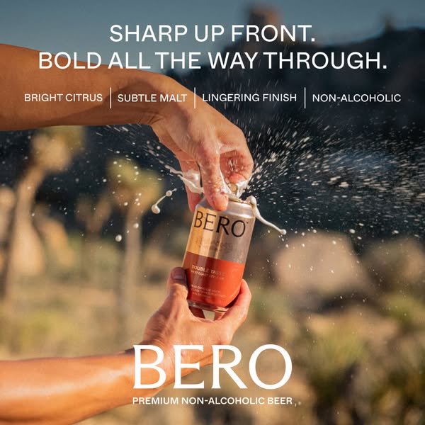 This image ad shows a hand opening a BERO non-alcoholic beer can, splashing the drink. It highlights the beer's tast