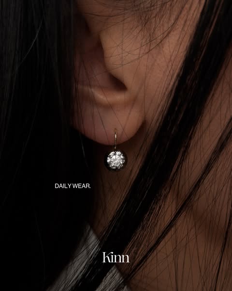 This ad features a close up view of a person wearing an earring, highlighting the earring in the shot.
