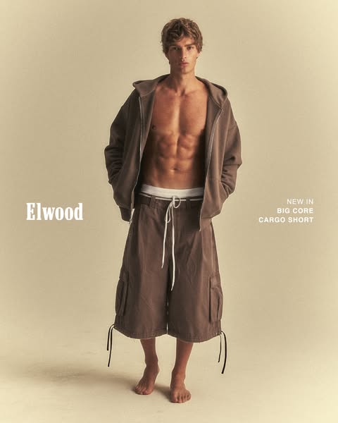 This ad features a male model showcasing Elwood brand clothing. The focus is on new cargo shorts, styled with a hoodie.