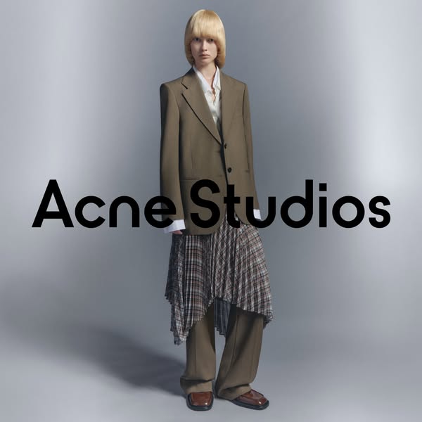This ad features a full-body shot of a model wearing Acne Studios clothing. The brand name is prominently displayed in t