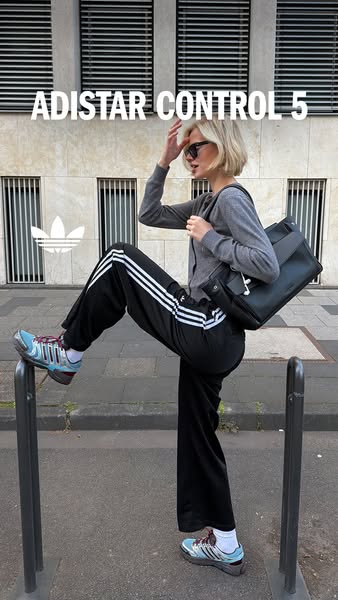 This image ad features the Adidas Adistar Control 5 athletic shoes. A fair-skinned woman with blonde hair and sunglasses