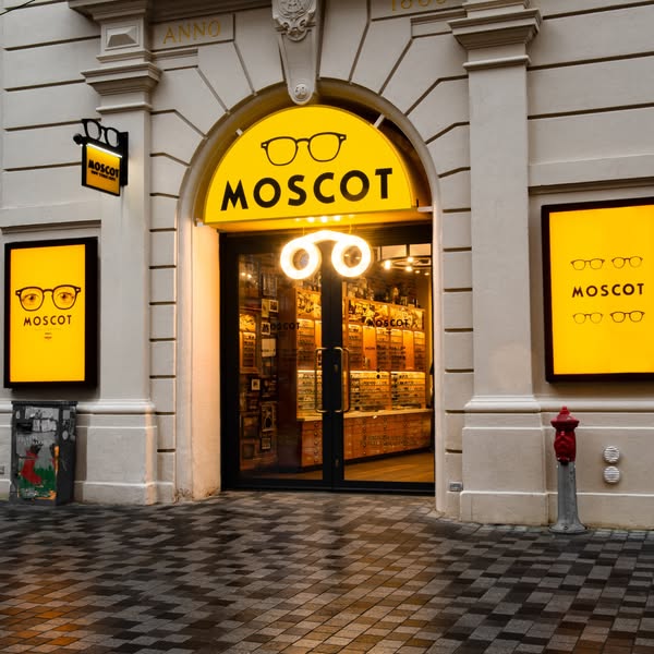 This image ad showcases the exterior of a Moscot store, emphasizing its classic and stylish brand identity through archi