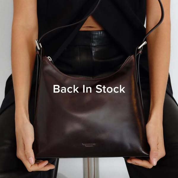 This is a simple image ad announcing that a product is back in stock. The image shows a woman holding a dark red leather