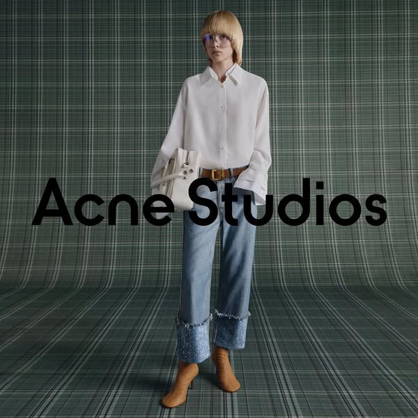 This Acne Studios ad features a model wearing the brand's clothing and accessories against a patterned backdrop, wit