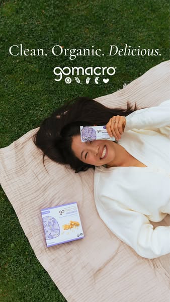 This ad features a woman lying on a blanket in a grassy area, presenting the brand GoMacro, and featuring their macrobar
