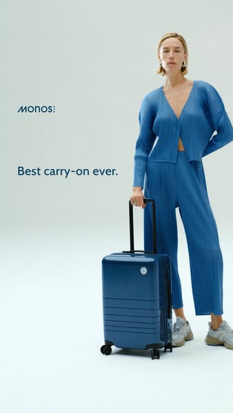 This ad features a woman standing next to a Monos carry-on suitcase. The ad highlights the suitcase as the 'best car