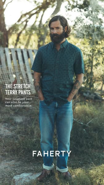 An image ad for Faherty brand stretch terry pants, showing a man wearing the pants standing in a grassy field.