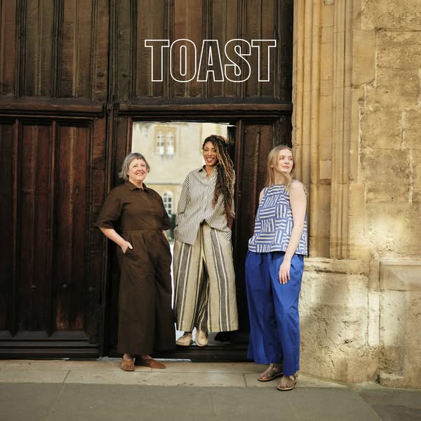 This image ad features three women of different ages and races modeling clothing from the brand TOAST. The women are sta