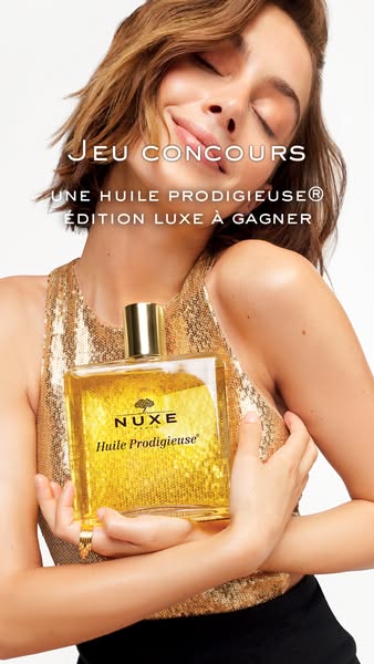 The ad image shows a woman holding Nuxe Huile Prodigieuse, with promotional text for a contest to win a luxury edition o