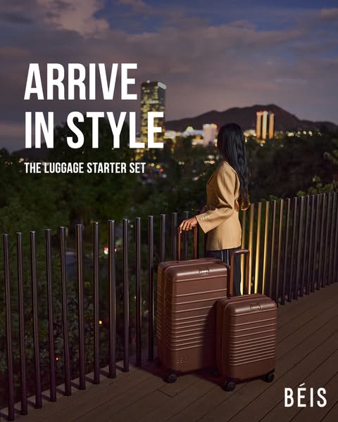 This image ad for BÉIS luggage features the luggage starter set in front of a cityscape at dusk. The ad copy emphasizes 
