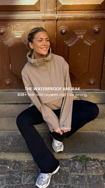 The ad highlights the waterproof anorak by showcasing a fashionable young woman wearing it and emphasizes the high numbe