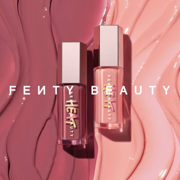 This image features two Fenty Beauty Heat lip glosses in different shades, set against a glossy backdrop in matching ton