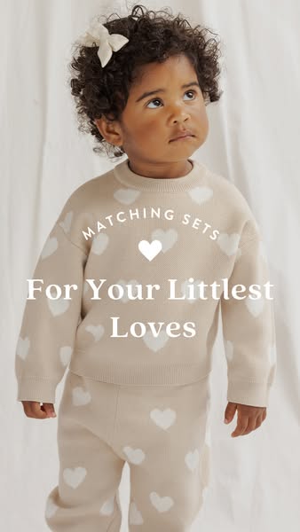 This ad features a young child wearing a matching sweater and pants set with white hearts. The ad promotes matching sets